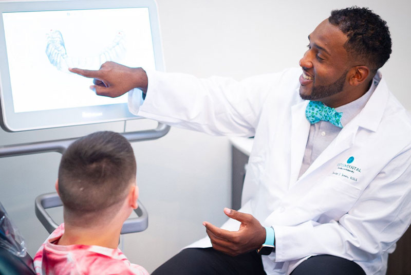 Dr. Jordan P Jones Showing A Pediatric Dental Patient Their Wisdom Teeth